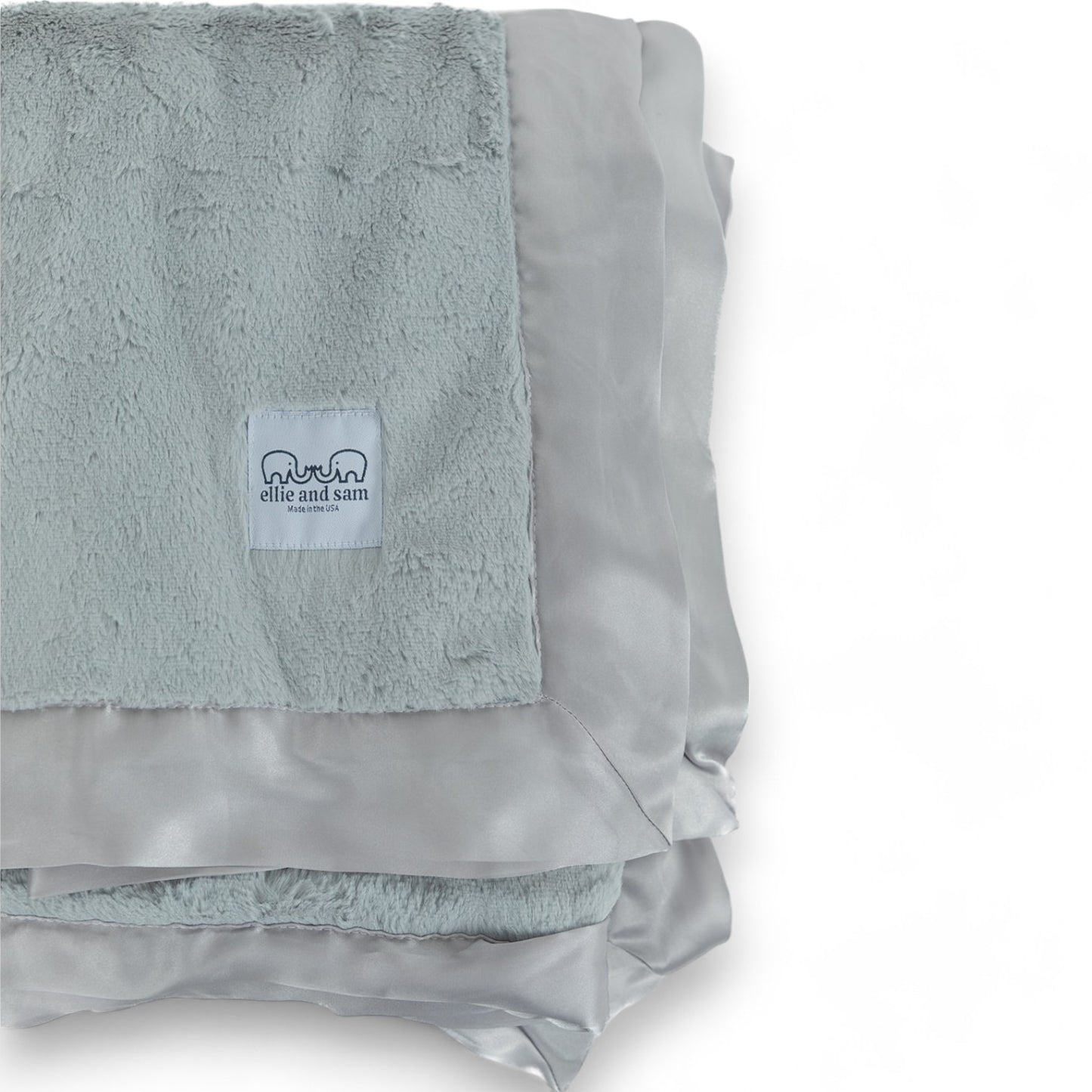 Silver throw blanket close up, thick soft pile and satin trim edge