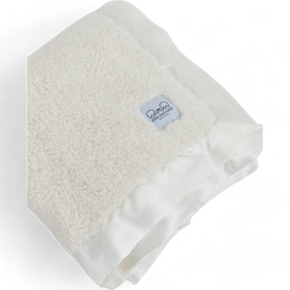 Ivory chenille throw blanket close up, plush texture and satin trim detail